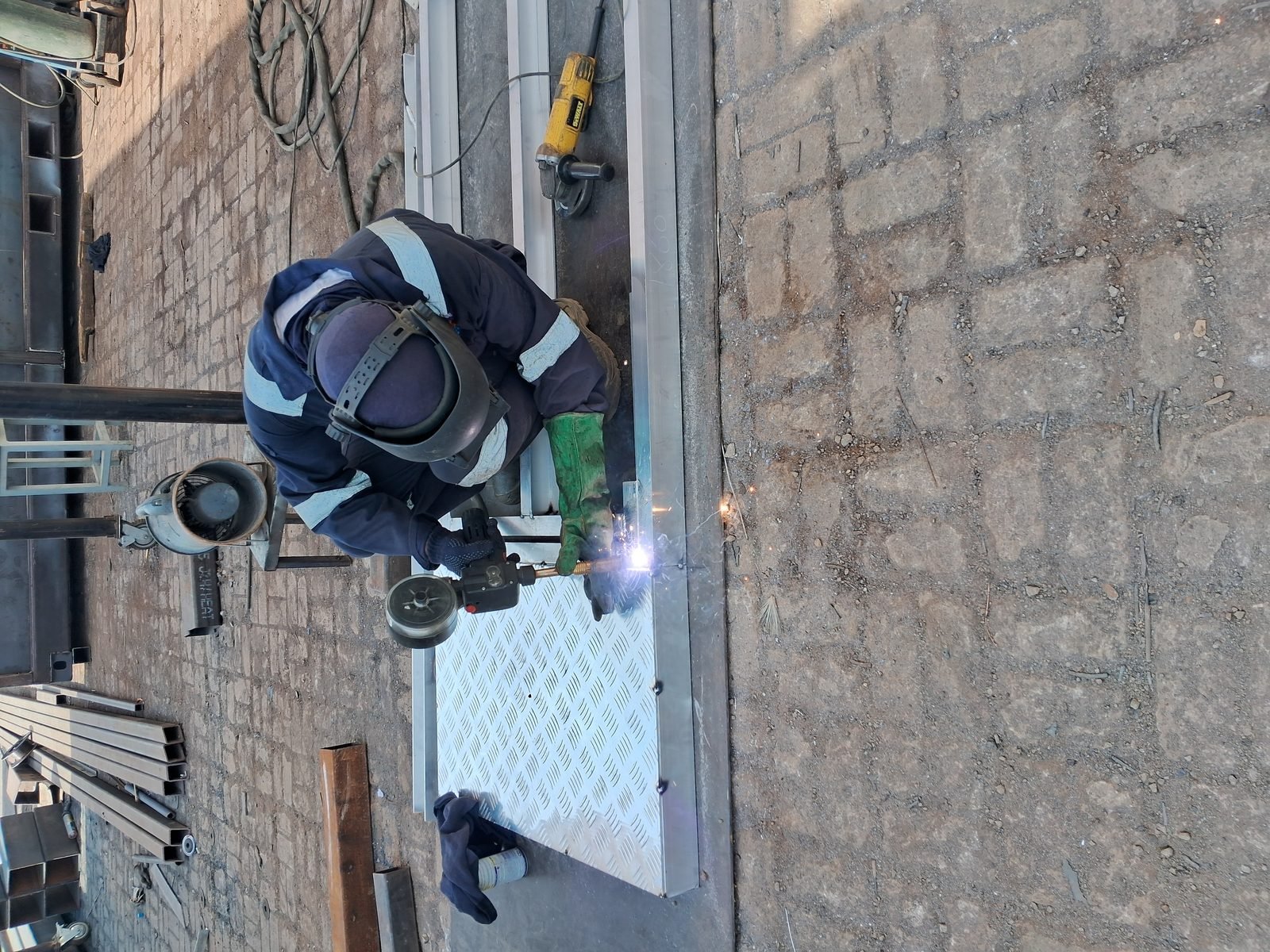 MMEW welder fabricating a steel component